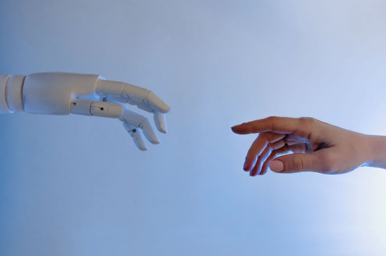 Generative design. A photo of 2 hands: a human and robot.