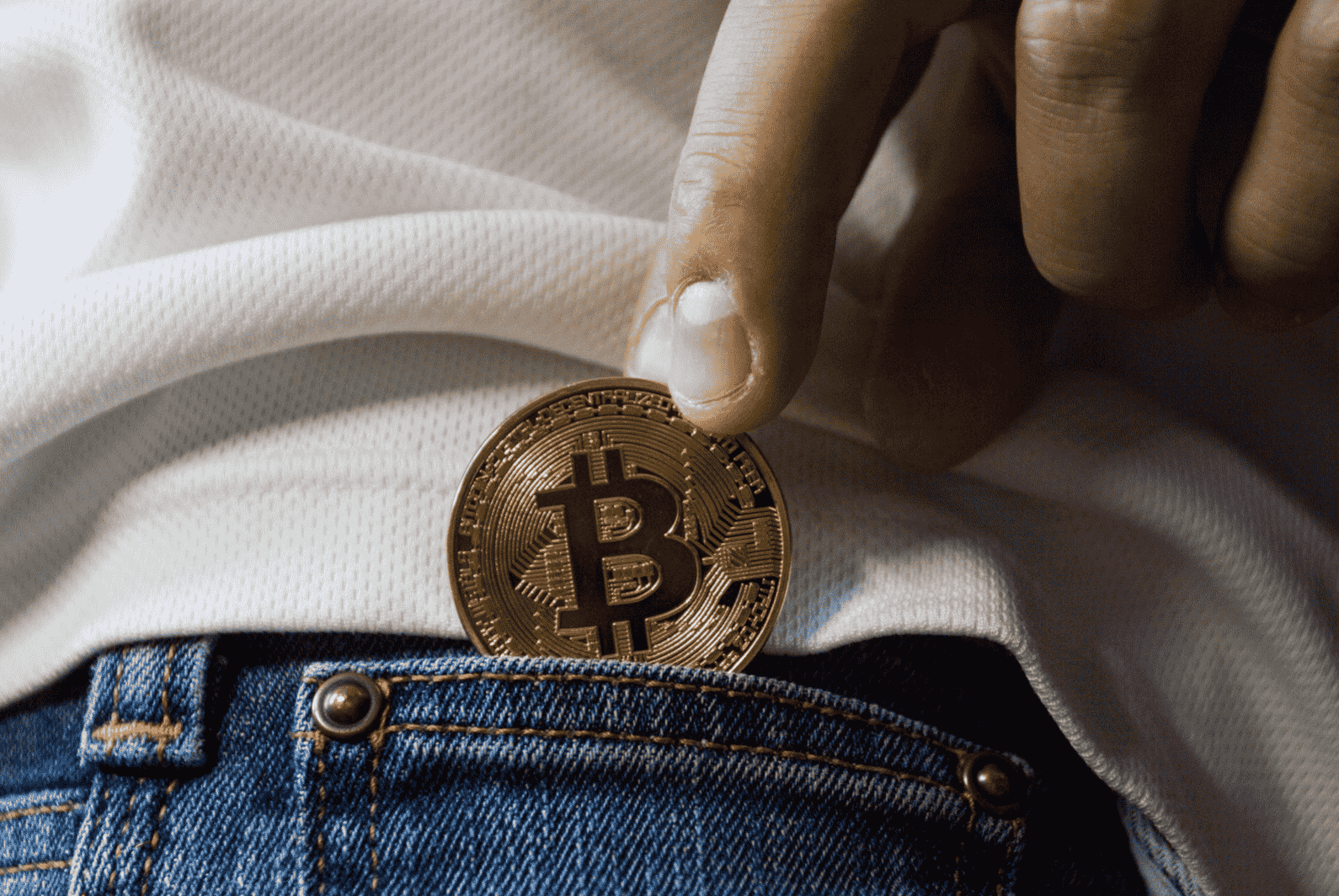 Bitcoin gambling. Coin of Bitcoin in a pocket.